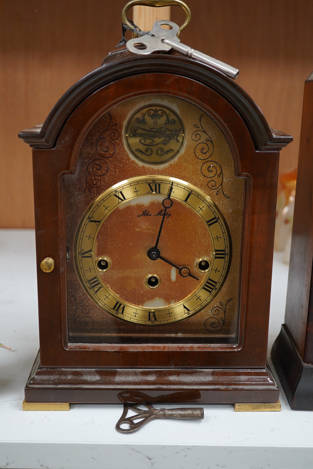 Two clocks including an American example, with keys and two military interest brass shells. Condition - fair